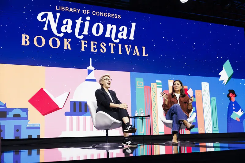 Kate McKinnon laughs while speaking with Amna Nawaz onstage at the August 22 National Book Festival