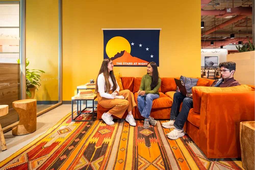 Employees sit in a colorful collaboration area inside Google's Austin Sail Tower office