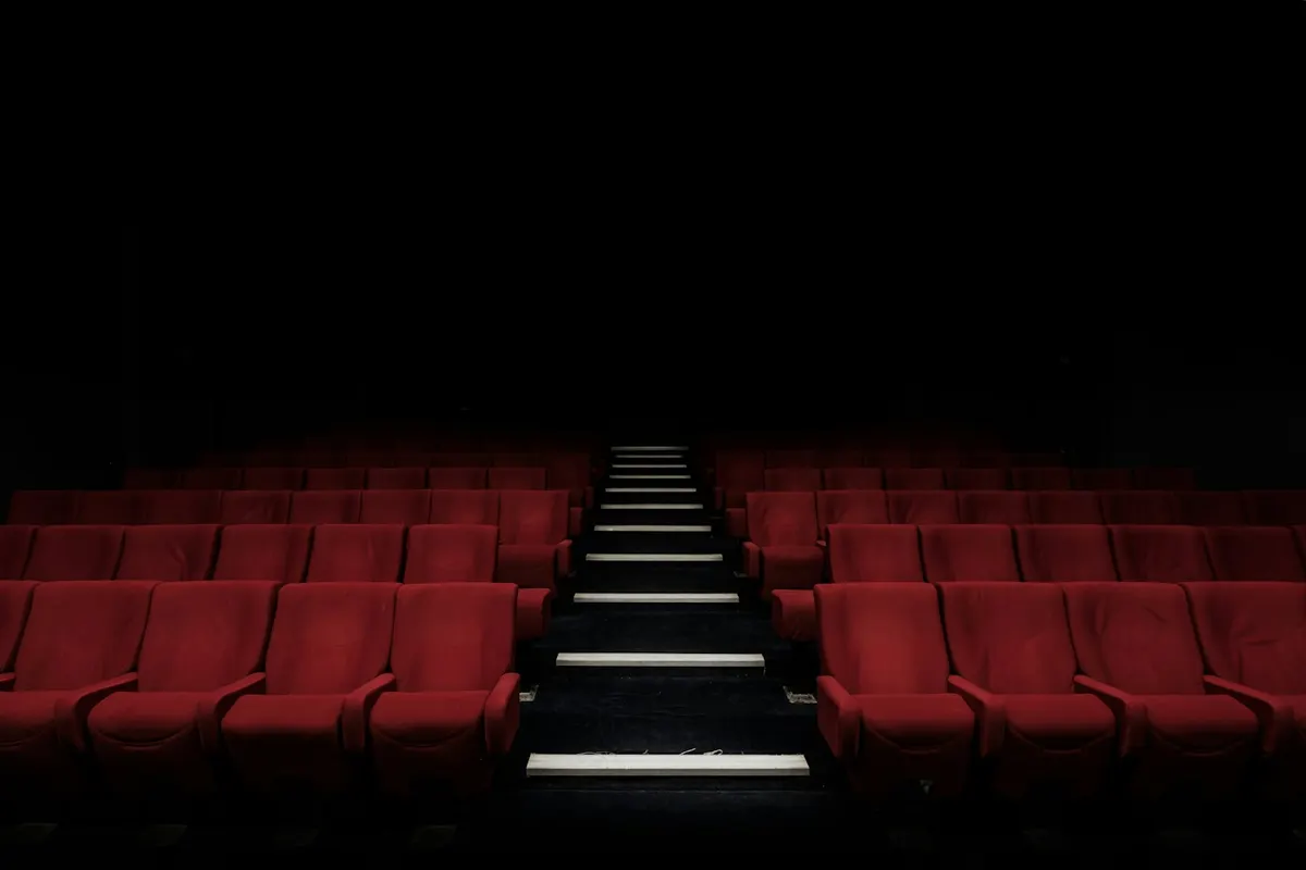 Red seats in a dark cinema auditorium