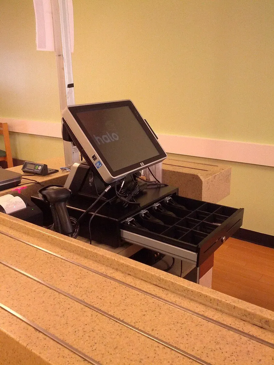 A cash register with its cash drawer open