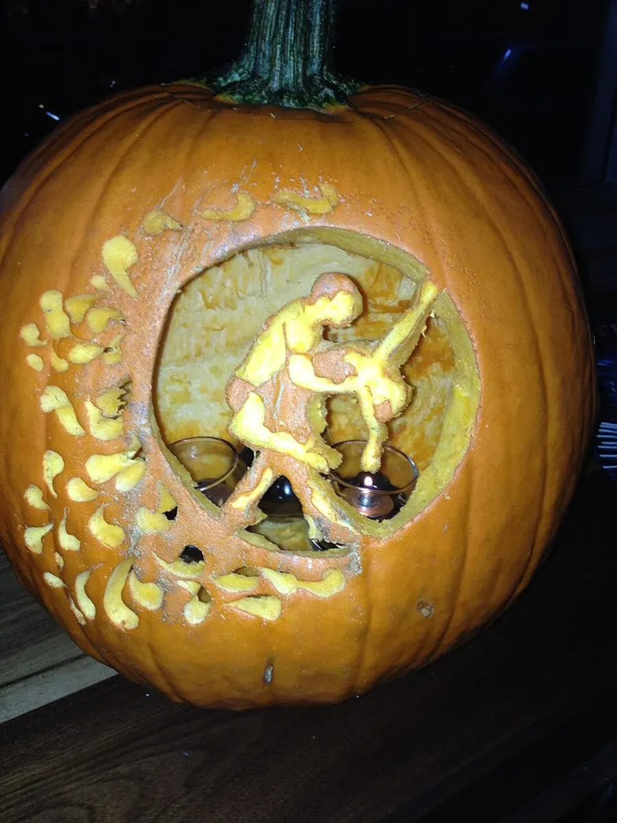 A carved pumpkin illuminated from inside