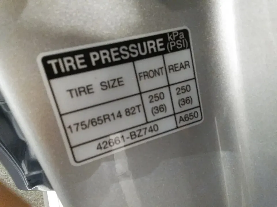 A vehicle door-jamb label showing tire-pressure information