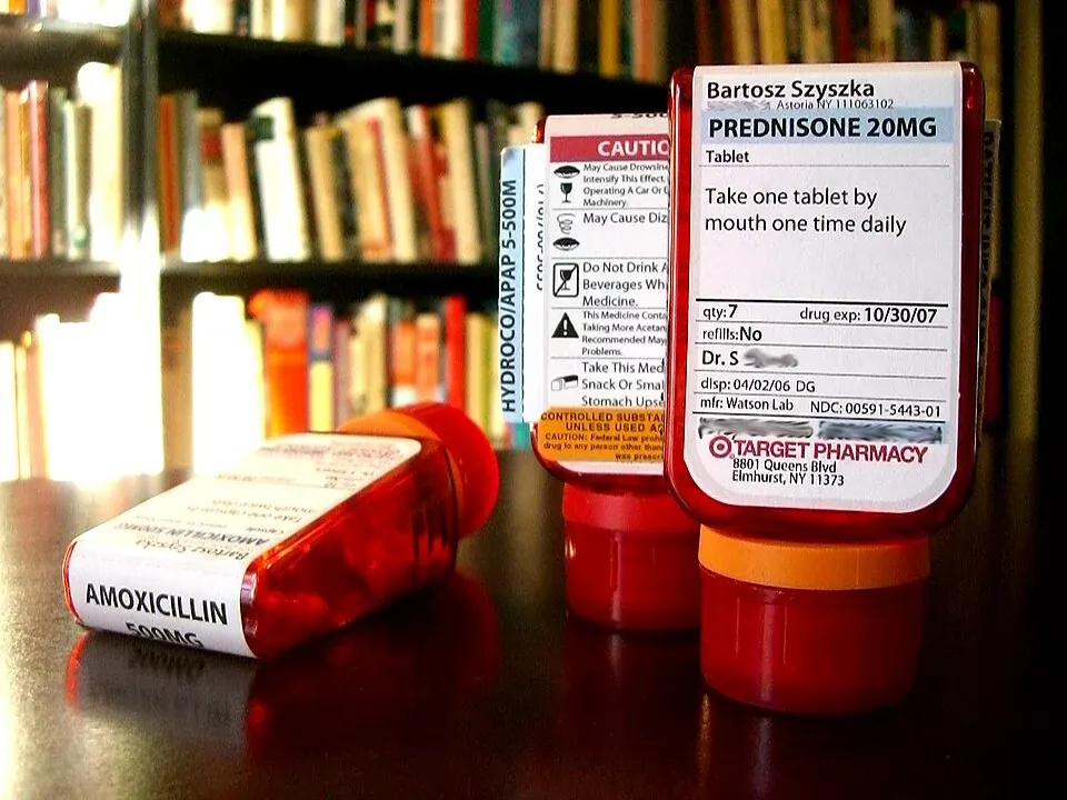 Three red prescription medicine bottles on a tabletop