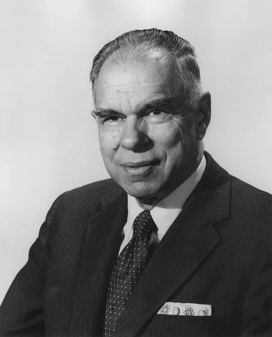 Black-and-white formal portrait of Glenn Seaborg wearing a suit