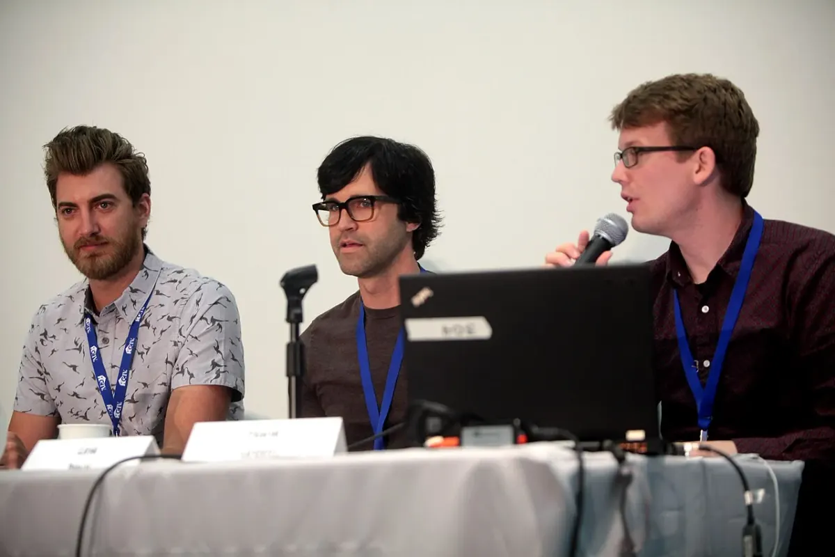 Rhett McLaughlin, Link Neal and Hank Green seated together at a convention panel