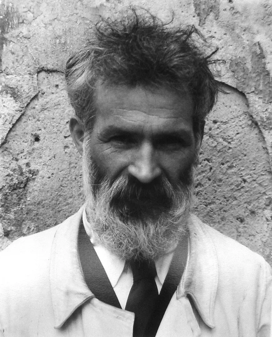 Black-and-white portrait of Constantin Brancusi with a beard and open-collar shirt
