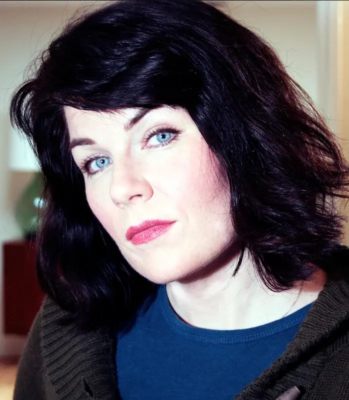Portrait of Karen Kilgariff with dark hair and a blue top