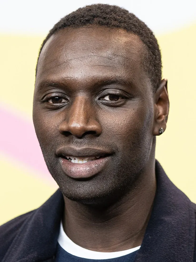Omar Sy in a dark jacket and white shirt at the Berlin Film Festival