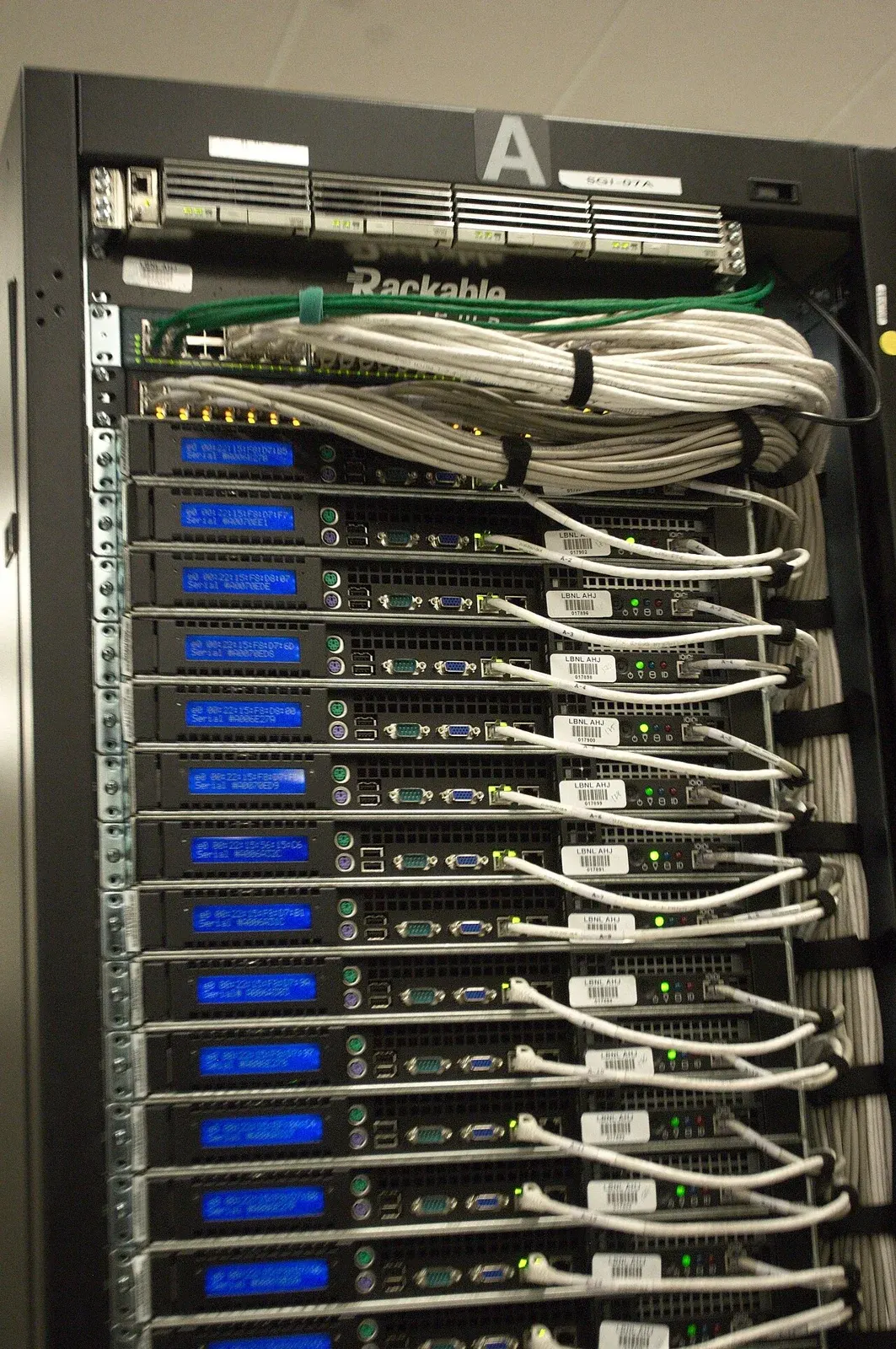 Rear of a server rack with bundled white network cables