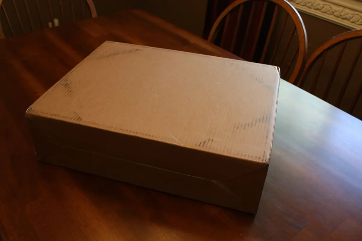 A cardboard shipping box on a table, illustrating an online purchase