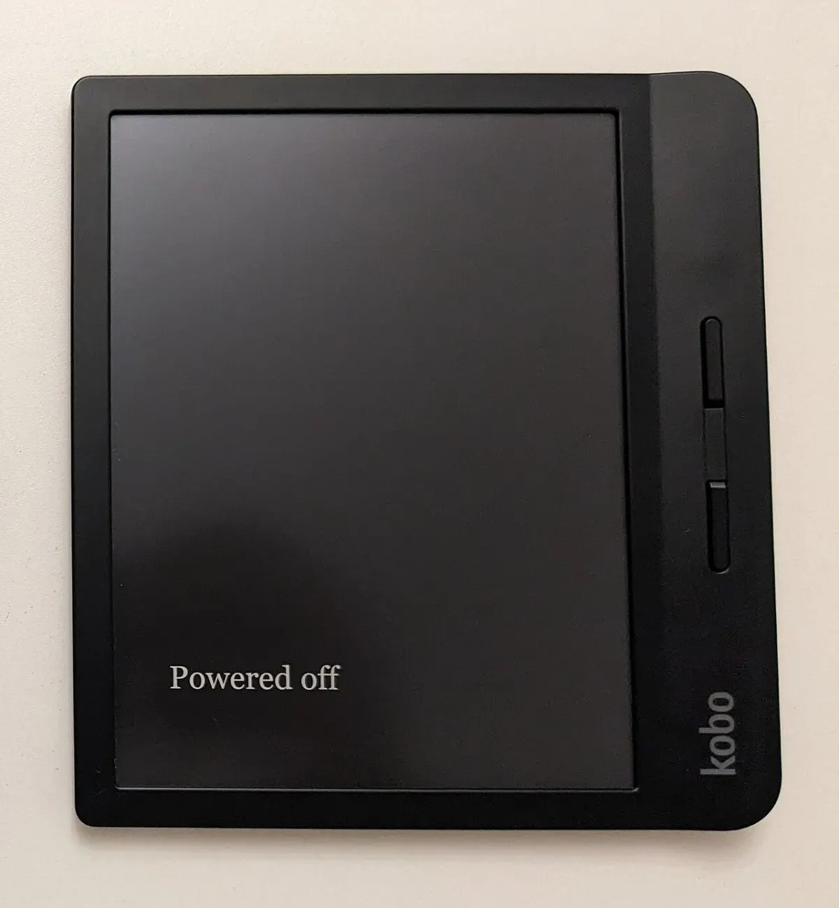 A Kobo H2O e-reader displaying a page of text; a contextual device photograph