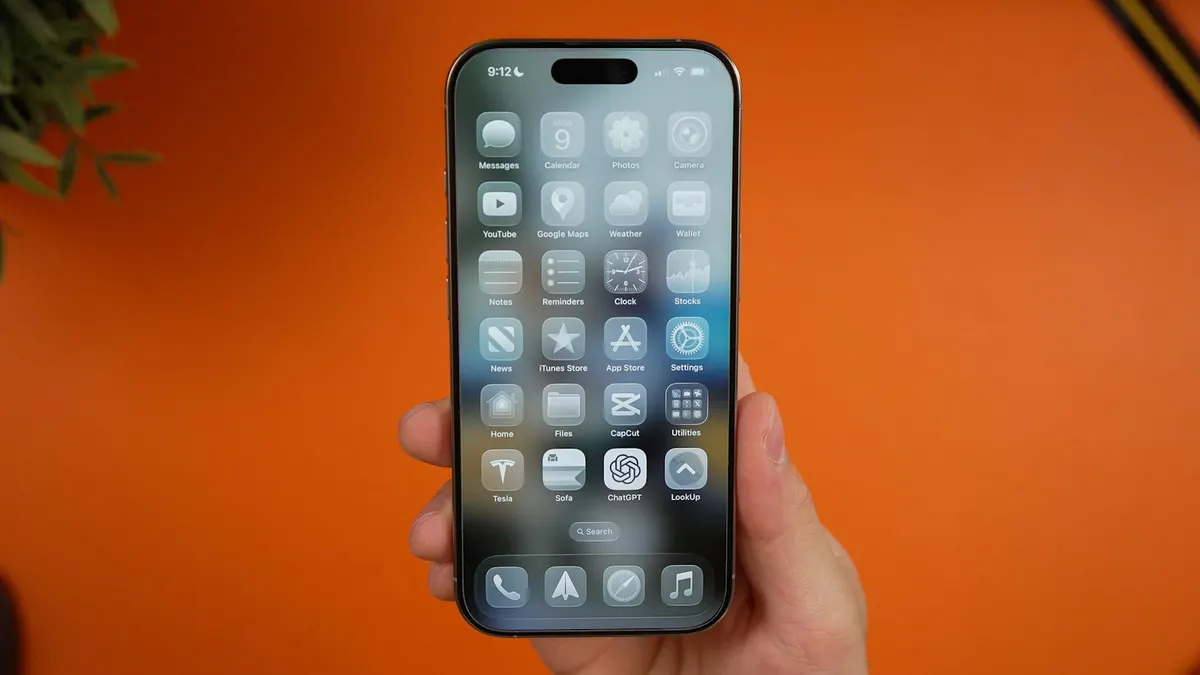 An iPhone held upright with its App Store and other app icons visible