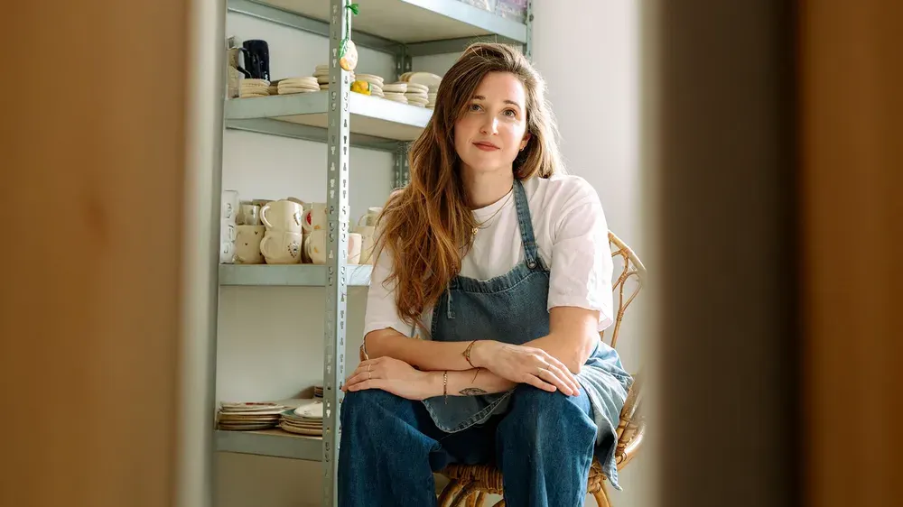 Ceramicist Morgane of Bleu Clémentine seated in her pottery studio