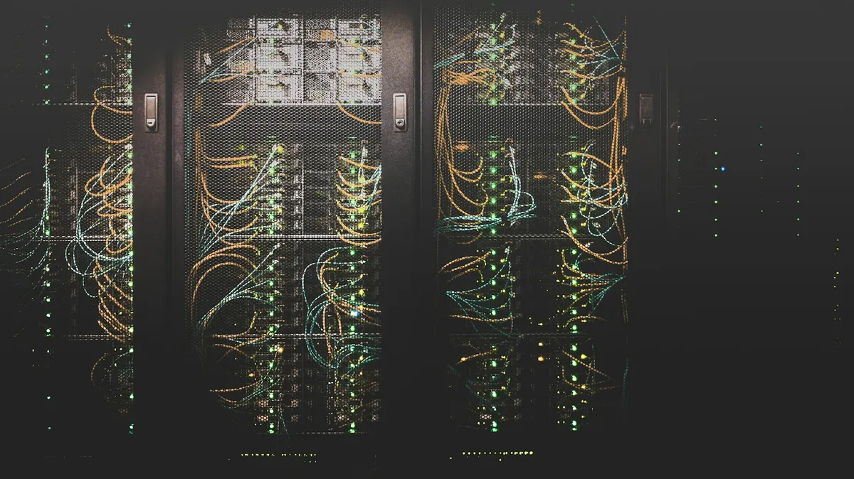 Network cables and equipment behind the mesh doors of server racks