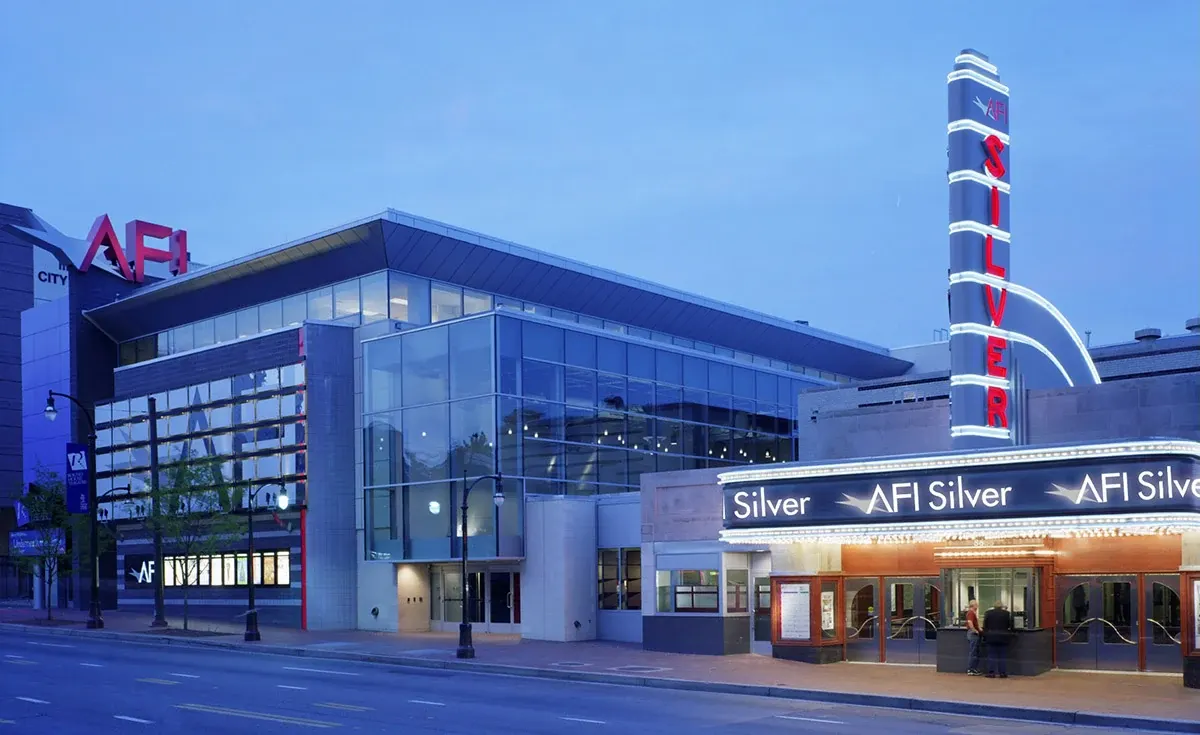 The illuminated AFI Silver Theatre marquee and glass-fronted building at dusk