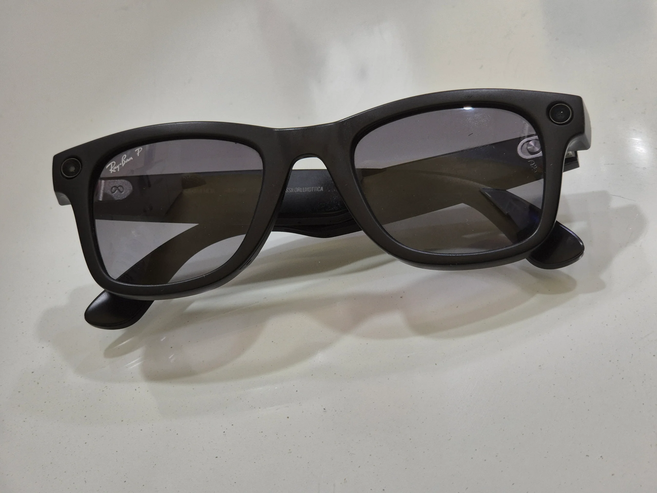 Front of black Ray-Ban Meta glasses showing the circular camera and indicator housings