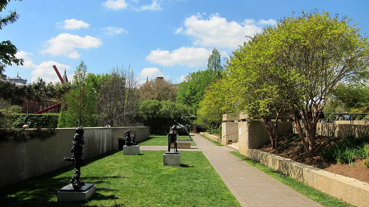 Trees, lawns, sculptures and a paved path in the Hirshhorn Sculpture Garden in April 2010.