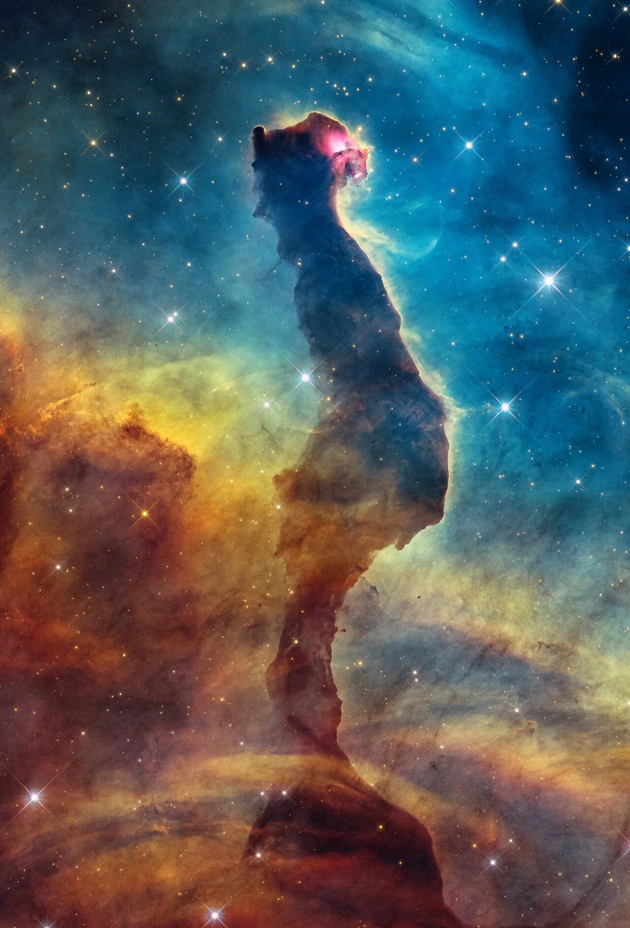 Hubble visible-light image of a dark, cat-shaped dust pillar with a bright pink eye region amid blue, yellow and red gas.