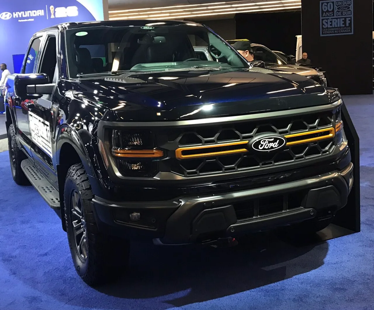 A black 2026 Ford F-150 displayed at the Montreal International Auto Show.