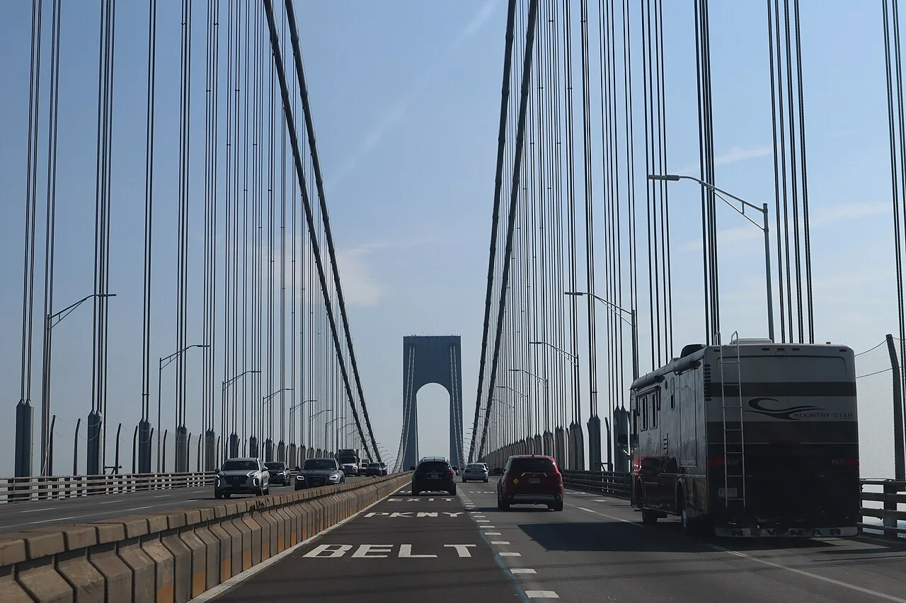 Vehicles travel across the Verrazzano-Narrows Bridge beneath its suspension cables.