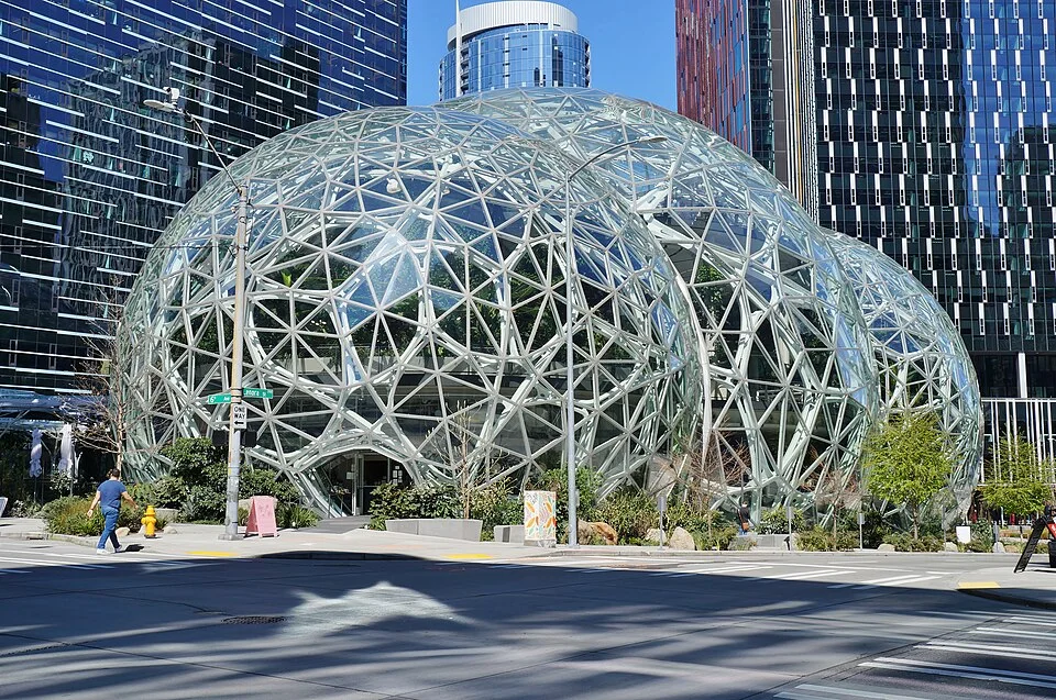 The glass-domed Amazon Spheres in front of high-rise office towers on a sunny day in Seattle