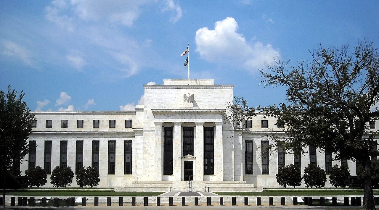 The white marble Eccles Building, headquarters of the Federal Reserve Board in Washington, under a blue sky