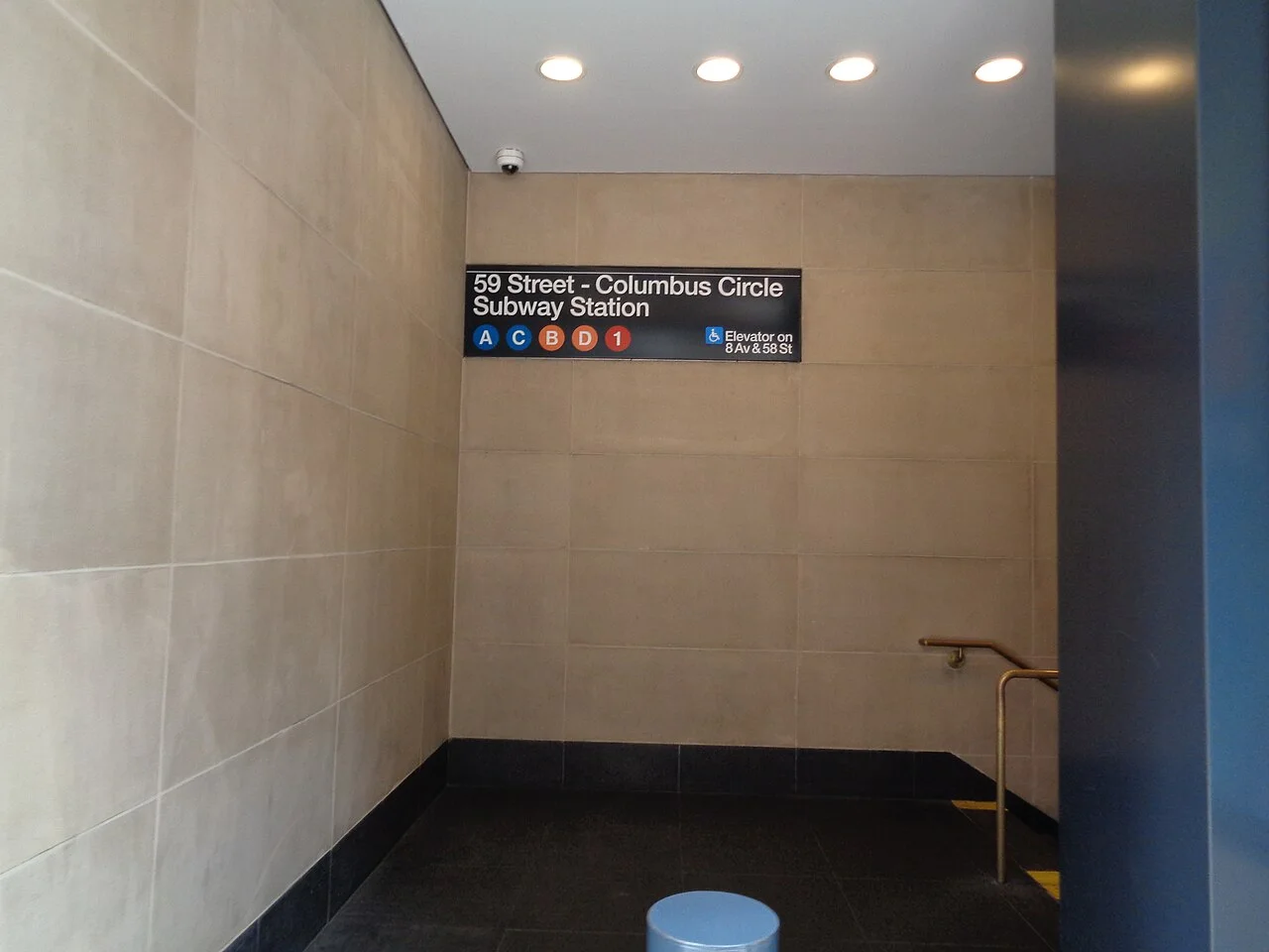 Stairs and a subway sign at an entrance to the 59th Street-Columbus Circle station inside Hearst Tower.