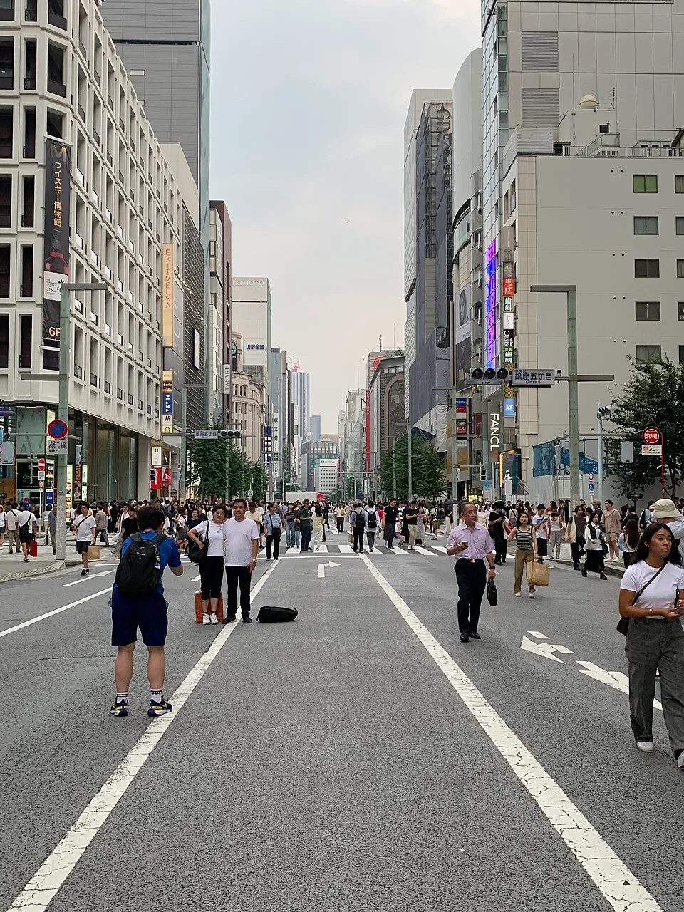 People walking on a car-free shopping street in Ginza, Tokyo