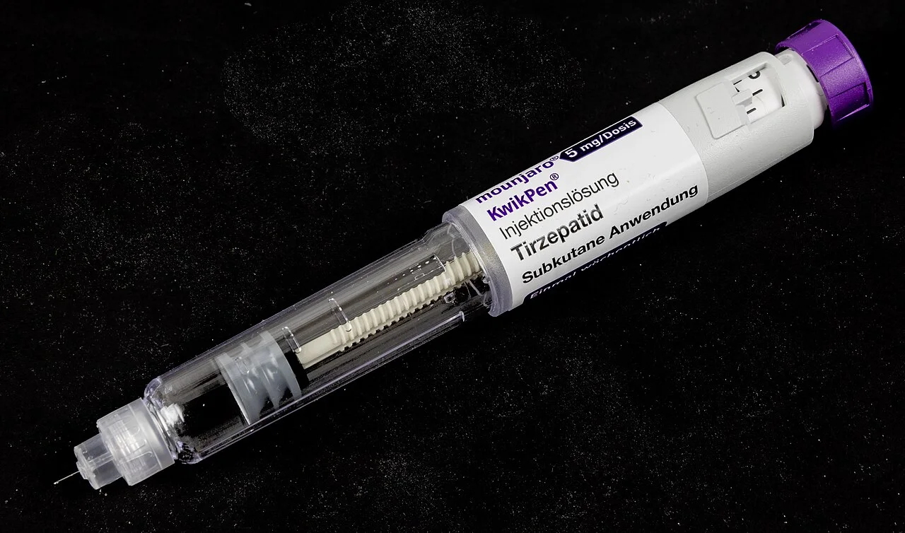 A Mounjaro KwikPen injector labeled 5 mg per dose on a black background