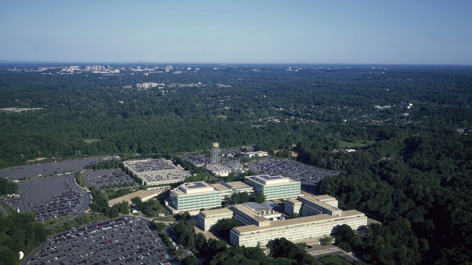 Aerial view of the CIA headquarters buildings and parking lots surrounded by forest in Langley, Virginia